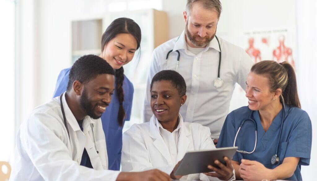 Doctors and nurses reviewing a tablet together